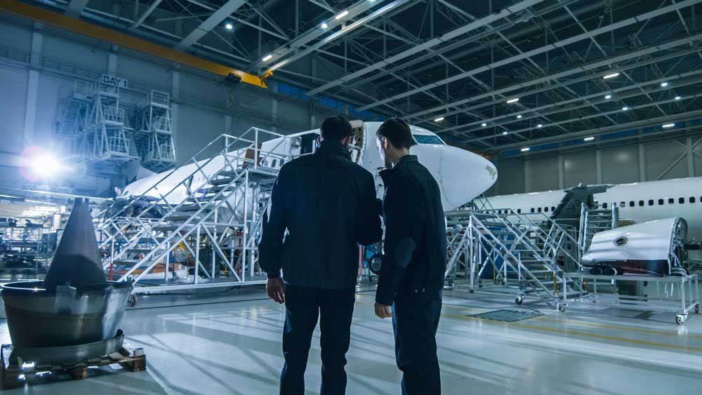 men-in-hangar-discussing-IoT-challenges-in-aviation
